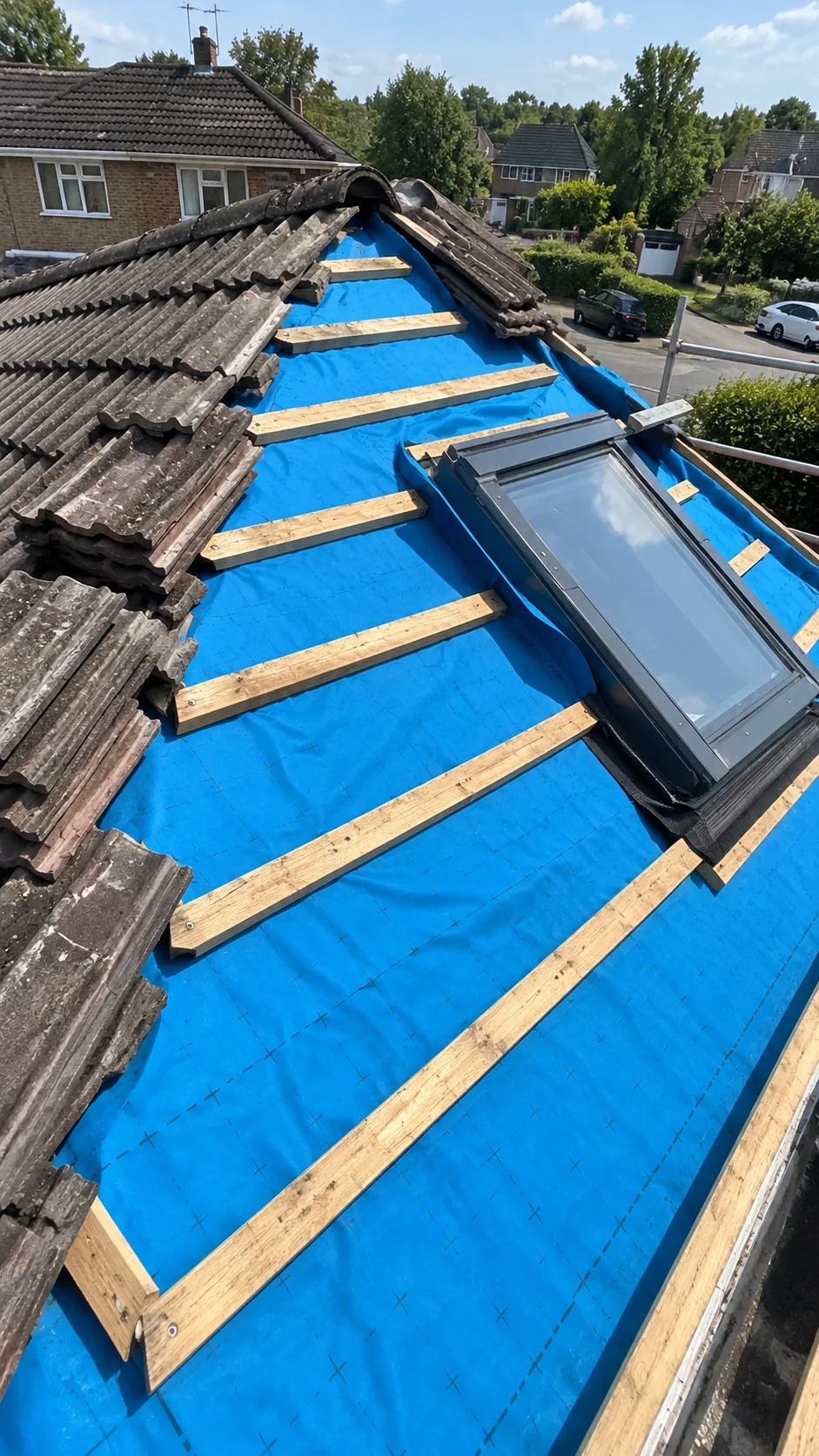 Roofer working on a chimney stack during a rooftop renovation over a suburban neighbourhood in Cavan
